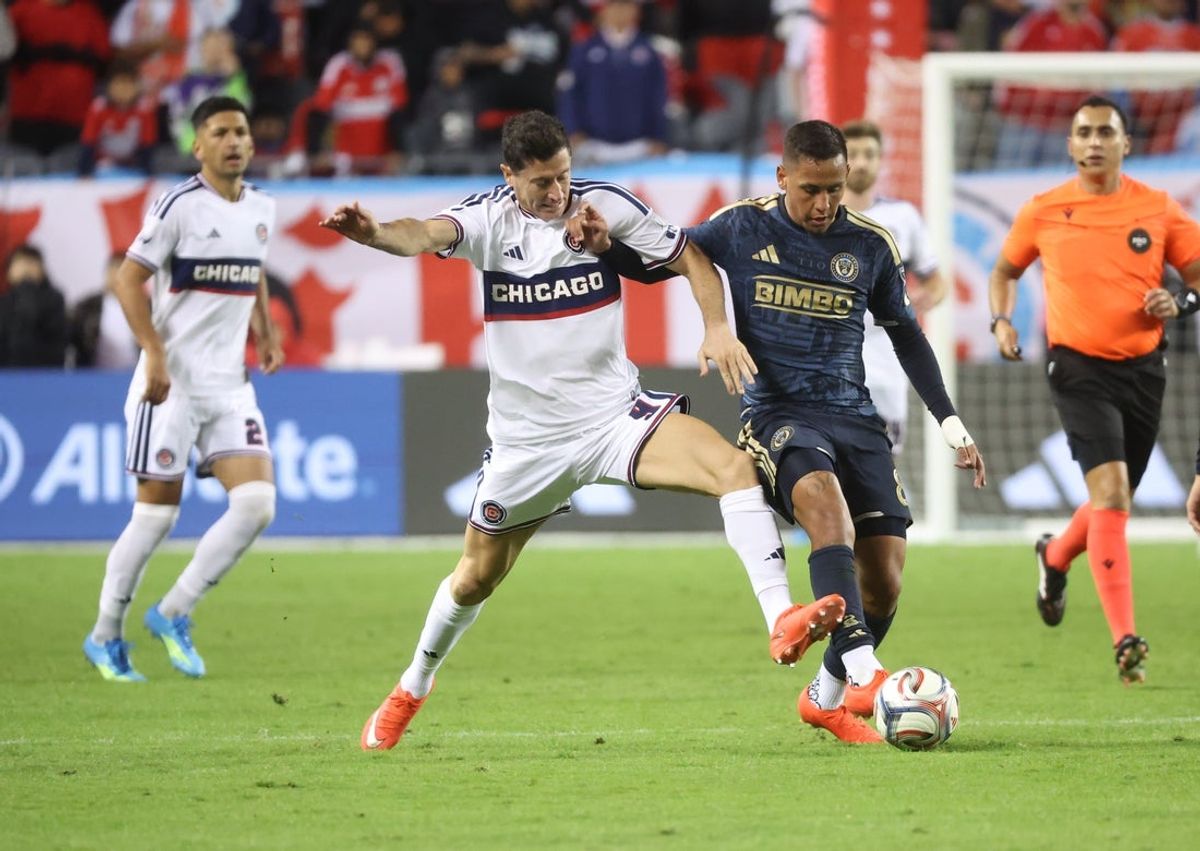 Oct 14, 2026; Chicago, Illinois, USA; Chicago Fire forward Robert Lewandowski (9) and Philadelphia Union midfielder Jesus Bueno (8) battle for control of the ball during the first half at Soldier Field. Mandatory Credit: Talia Sprague-Imagn Images