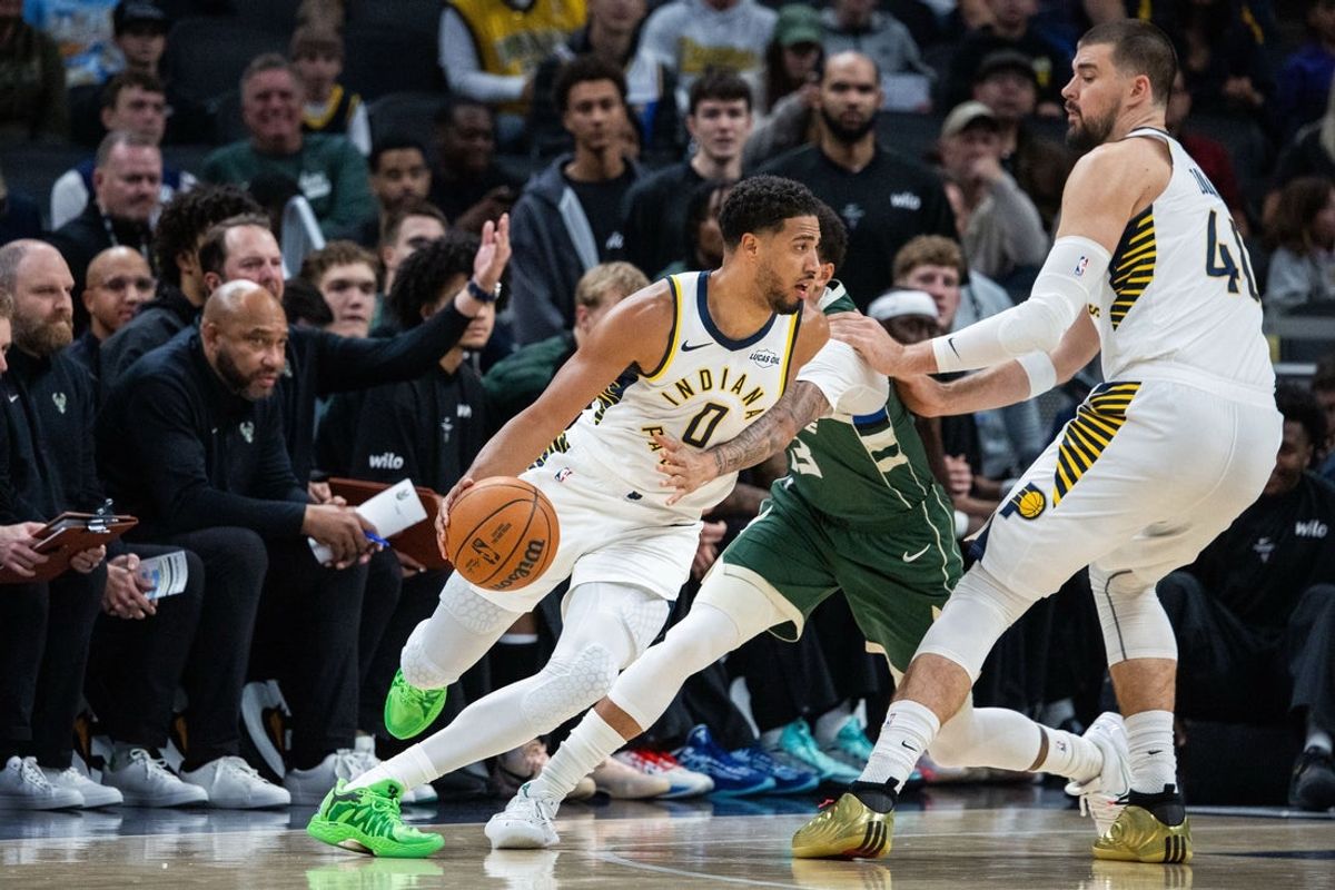 Oct 16, 2026; Indianapolis, Indiana, USA;  Indiana Pacers guard Tyrese Haliburton (0) dribbles the ball while Milwaukee Bucks guard Ryan Rollins (13) defends in he first half at Gainbridge Fieldhouse.  Mandatory Credit: Trevor Ruszkowski-Imagn Images
