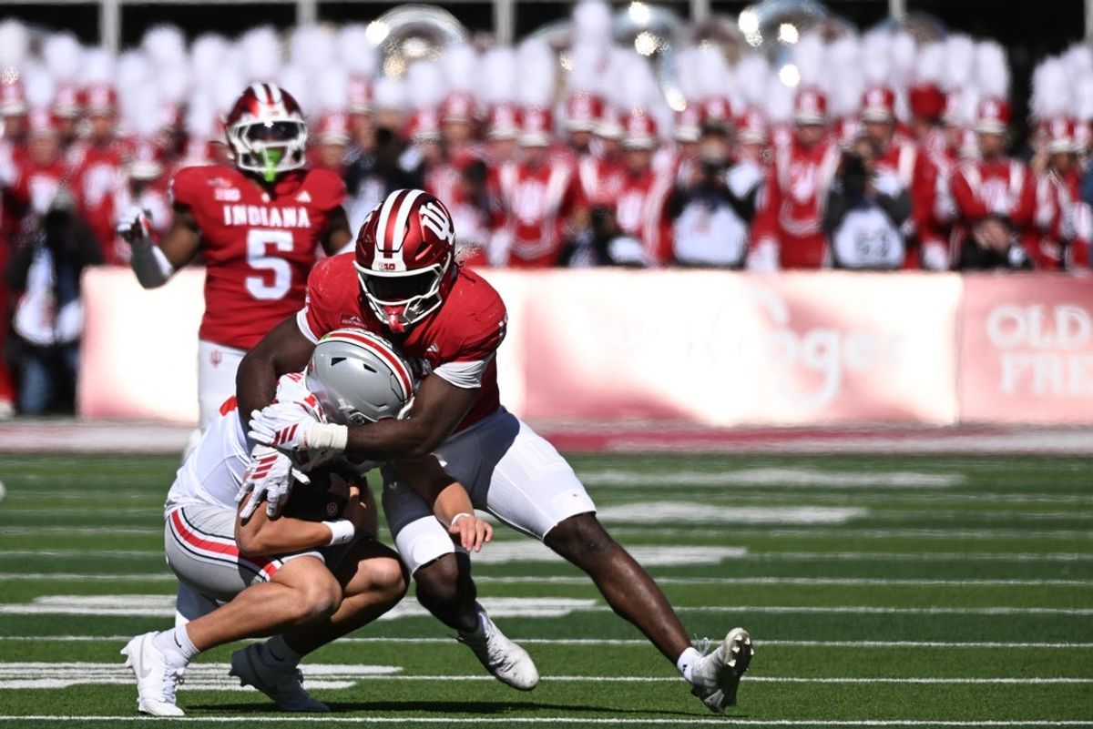 Oct 17, 2026; Bloomington, Indiana, USA;  Indiana Hoosiers defensive line Tobi Osunsanmi (12) sacks Ohio State Buckeyes quarterback Julian Sayin (10) during the first half at Merchants Bank Field at Memorial Stadium.  Mandatory Credit: Robert Goddin-Imagn Images