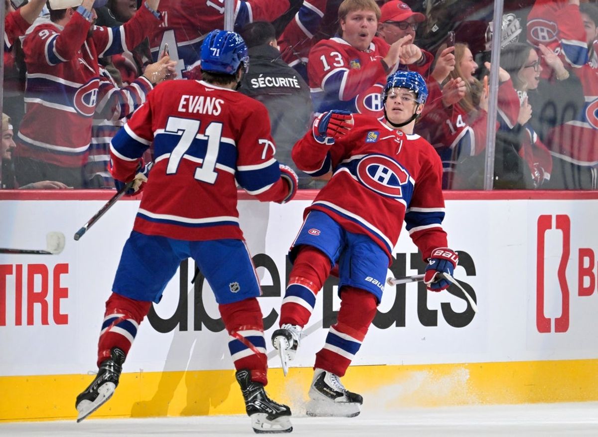 Oct 17, 2026; Montreal, Quebec, CAN;  Montreal Canadiens forward Cole Caufield (13) celebrates with teammate forward Jake Evans (71) after scoring the game winning  goal against the Buffalo Sabres during the overtime period at the Bell Centre.  Mandatory Credit: Eric Bolte-Imagn Images