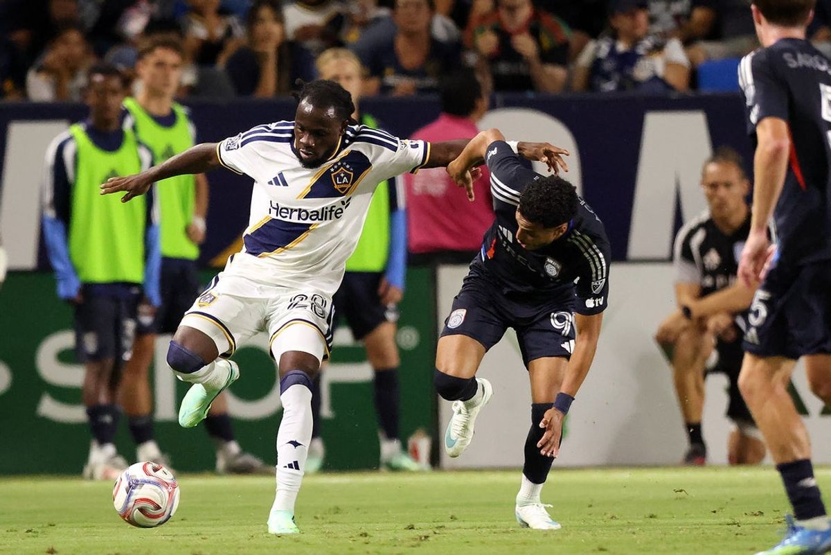 Oct 17, 2026; Carson, California, USA;  LA Galaxy forward Joseph Paintsil (28) fights for the ball against San Diego FC midfielder Elias Achouri (99) during the second half at Dignity Health Sports Park. Mandatory Credit: Kiyoshi Mio-Imagn Images