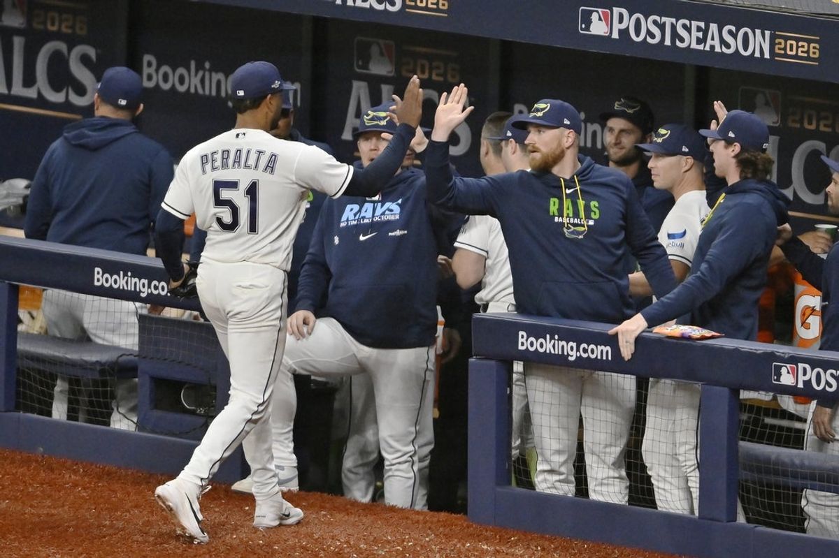 Oct 19, 2026; St. Petersburg, Florida, USA;  Tampa Bay Rays pitcher Freddy Peralta (51) celebrates with the dugout during the third inning against the Cleveland Guardians in game six of the ALCS for the 2026 MLB Playoffs at Tropicana Field.  Mandatory Credit: Pablo Robles-Imagn Images