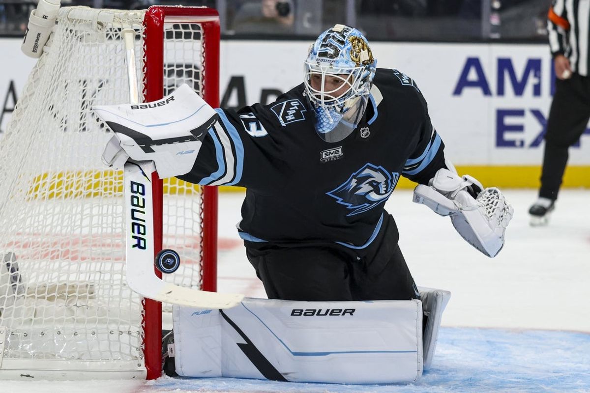 Oct 19, 2026; Salt Lake City, Utah, USA;  Utah Mammoth goaltender Sebastian Cossa (33) blocks a shot with his stick during the second period of the game against the Pittsburgh Penguins at Delta Center.  Mandatory Credit: Rob Gray-Imagn Images
