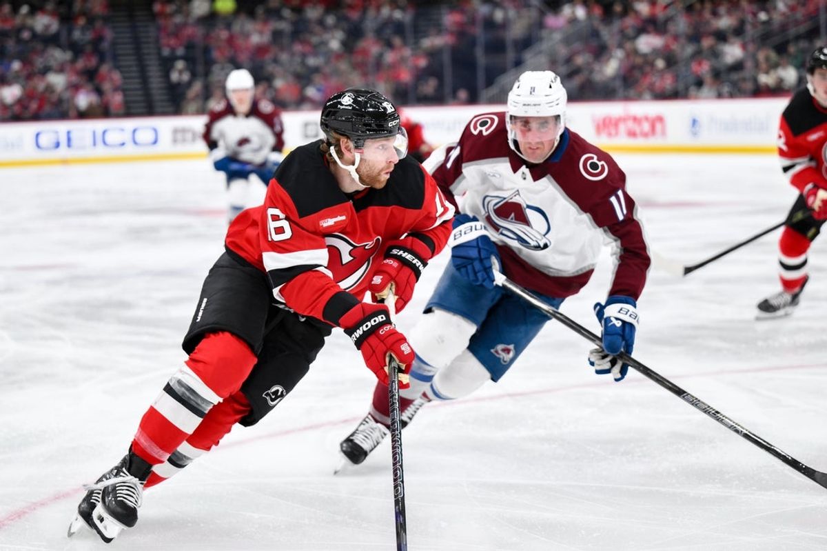 Oct 20, 2026; Newark, New Jersey, USA;  New Jersey Devils right wing Connor Brown (16) skates with the puck while defended by Colorado Avalanche center Brock Nelson (11) during the second period at Prudential Center.  Mandatory Credit: John Jones-Imagn Images