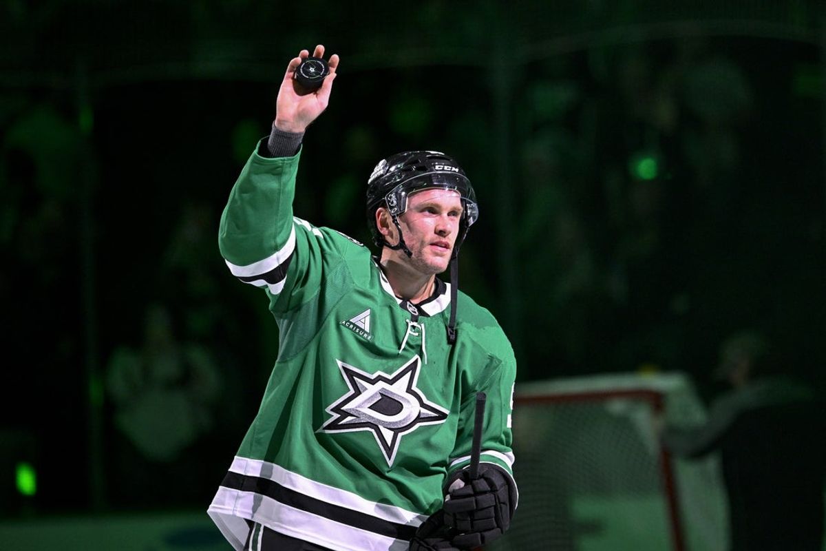 Oct 20, 2026; Dallas, Texas, USA; Dallas Stars right wing Mikko Rantanen (96) tosses a puck to the fans after he scores the game winning goal against the Boston Bruins during the overtime period at the American Airlines Center. Mandatory Credit: Jerome Miron-Imagn Images