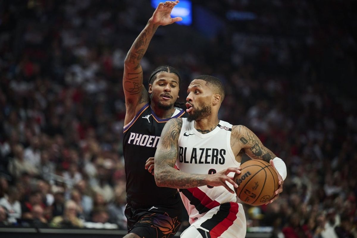 Oct 21, 2026; Portland, Oregon, USA; Portland Trail Blazers guard Damian Lillard (0) drives to the basket during the first half against Phoenix Suns guard Jalen Green (4) at Moda Center. Mandatory Credit: Troy Wayrynen-Imagn Images