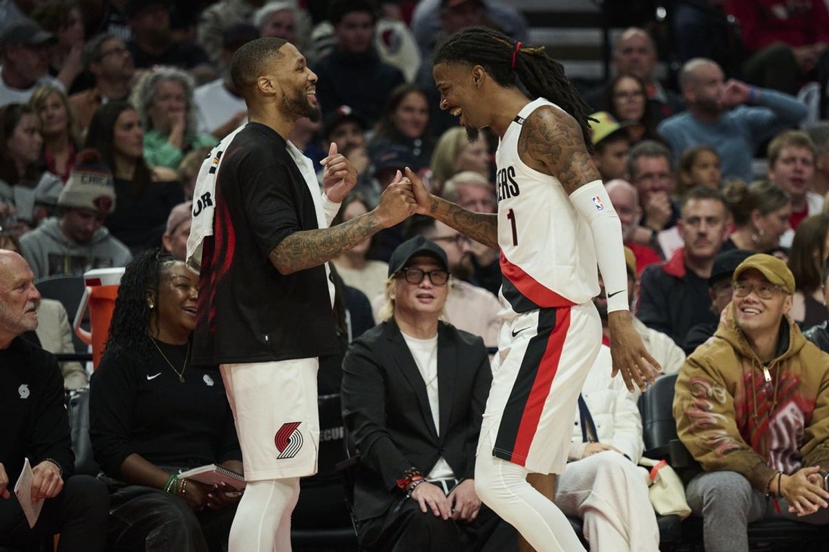 Oct 21, 2026; Portland, Oregon, USA; Portland Trail Blazers guard Damian Lillard (0), left, high fives guard Ja Morant (1) during the second half in a game against the Phoenix Suns at Moda Center. Mandatory Credit: Troy Wayrynen-Imagn Images