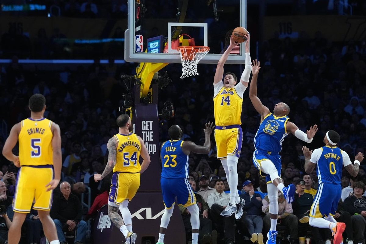 Oct 21, 2026; Los Angeles, California, USA; Los Angeles Lakers center Walker Kessler (14) reaches for the ball against Golden State Warriors center Al Horford (20) in the second half at Crypto.com Arena. Mandatory Credit: Kirby Lee-Imagn Images