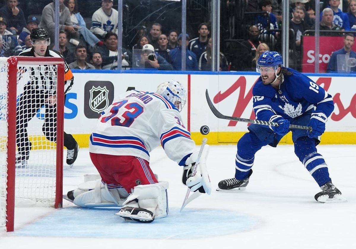 Oct 22, 2026; Toronto, Ontario, CAN;  New York Rangers goaltender Dylan Garand (33) stops the puck on Toronto Maple Leafs center Zack MacEwen (19) during the first period at Scotiabank Arena.  Mandatory Credit: Nick Turchiaro-Imagn Images