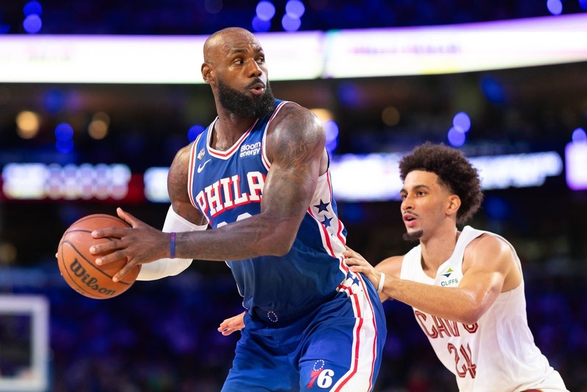 Oct 22, 2026; Philadelphia, Pennsylvania, USA; Philadelphia 76ers forward LeBron James (23) controls the ball against Cleveland Cavaliers guard Tyrese Proctor (24) during the second quarter at Xfinity Mobile Arena. Mandatory Credit: Bill Streicher-Imagn Images