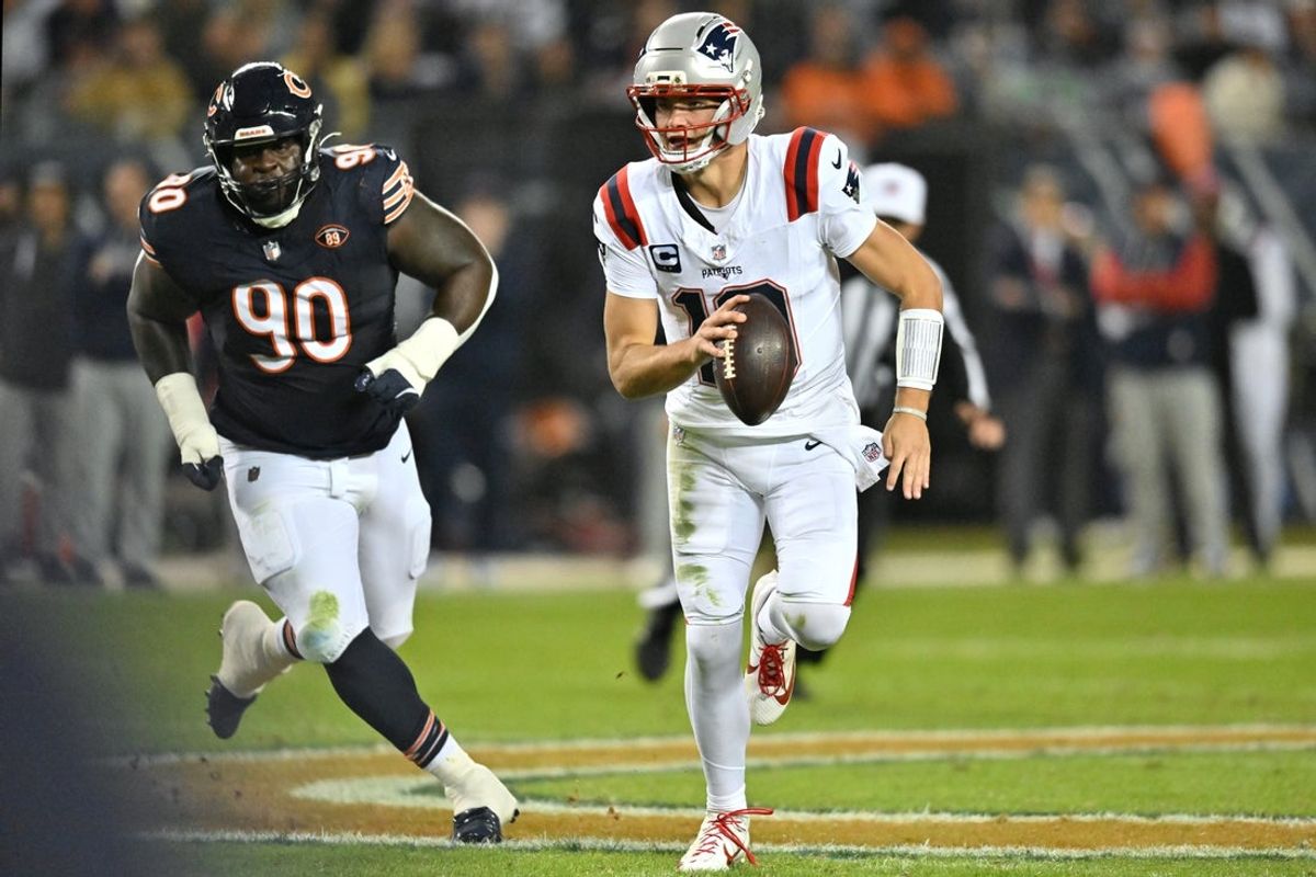 Oct 22, 2026; Chicago, Illinois, USA;  New England Patriots quarterback Drake Maye (10) runs the ball against Chicago Bears defensive tackle Neville Gallimore (90) during the first half at Soldier Field.  Mandatory Credit: Patrick Gorski-Imagn Images