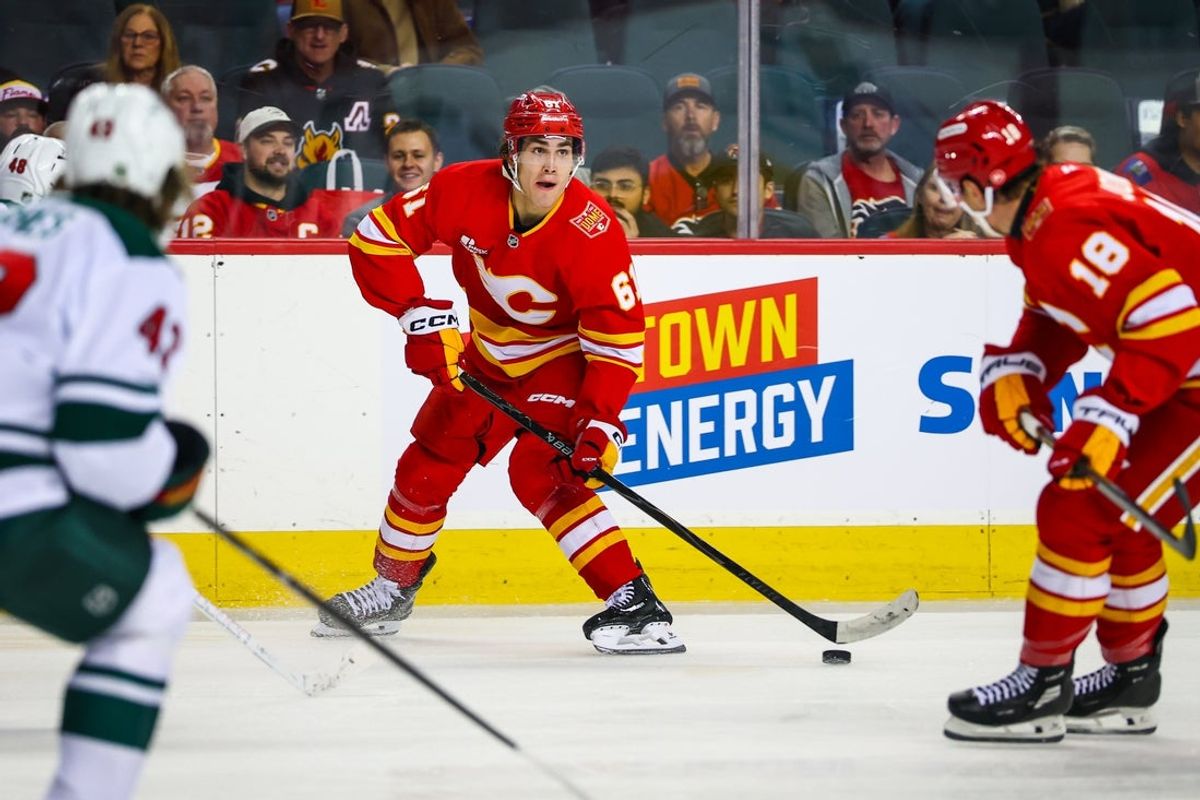 Oct 22, 2026; Calgary, Alberta, CAN; Calgary Flames left wing Aydar Suniev (61) controls the puck against the Minnesota Wild during the second period at Scotiabank Saddledome. Mandatory Credit: Sergei Belski-Imagn Images