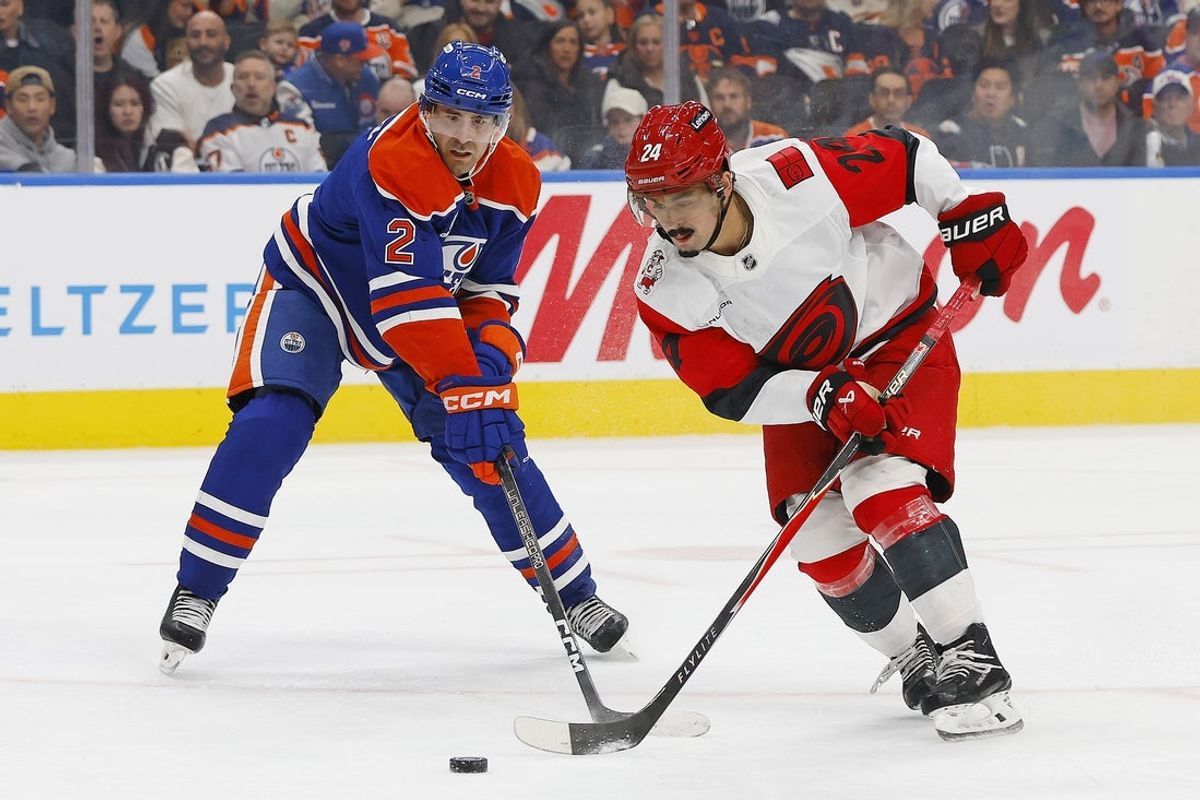Oct 22, 2026; Edmonton, Alberta, CAN;  Carolina Hurricanes forward Seth Jarvis (24) carries the puck around Edmonton Oilers defensemen Evan Bouchard (2) during the second period at Rogers Place.  Mandatory Credit: Perry Nelson-Imagn Images