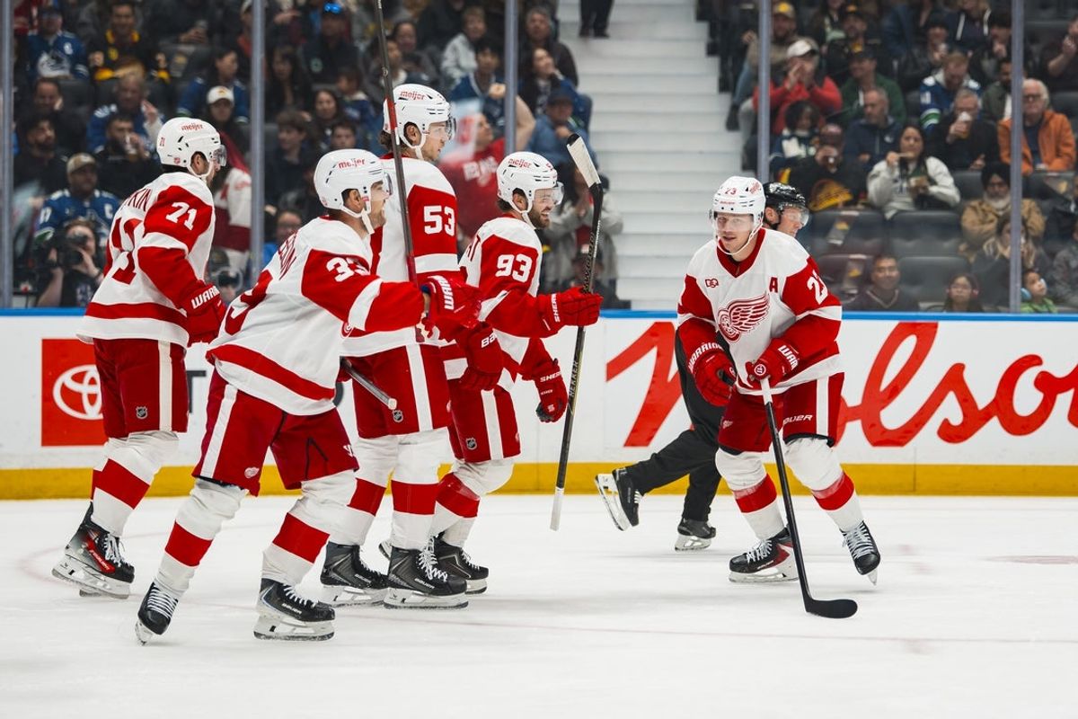 Oct 22, 2026; Vancouver, British Columbia, CAN;  Detroit Red Wings forward Lucas Raymond (23) celebrates his goal his second goal of the period with forward Dylan Larkin (71) and forward Viktor Arvidsson (33) and defenseman Moritz Seider (53) and forward Alex DeBrincat (93) against the Vancouver Canucks in the first period at Rogers Arena.  Mandatory Credit: Bob Frid-Imagn Images