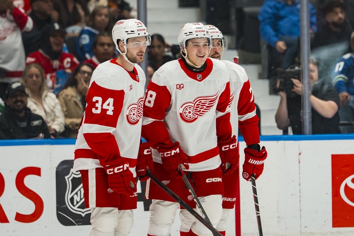 Oct 22, 2026; Vancouver, British Columbia, CAN;  Detroit Red Wings forward Emmitt Finnie (58) celebrates his goal with forward Carter Mazur (34) and defenseman Justin Faulk (72) against the Vancouver Canucks in the third period at Rogers Arena.  Mandatory Credit: Bob Frid-Imagn Images