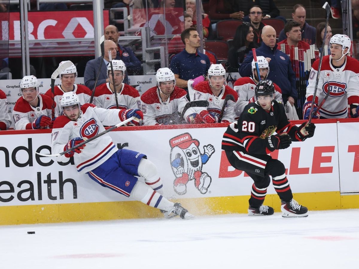 Oct 23, 2026; Chicago, Illinois, USA; Montreal Canadiens center Kirby Dach (77) and Chicago Blackhawks center Ryan Greene (20) battle for control of the puck during the first period at United Center. Mandatory Credit: Talia Sprague-Imagn Images