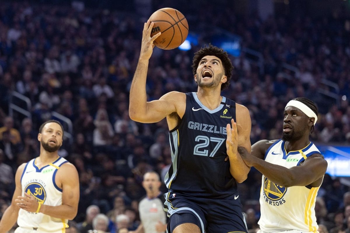 Oct 23, 2026; San Francisco, California, USA;  Memphis Grizzlies forward Cameron Boozer (27) drives to the basket ahead of Golden State Warriors forward Graham Ike (45) during the first quarter at Chase Center.  Mandatory Credit: D. Ross Cameron-Imagn Images