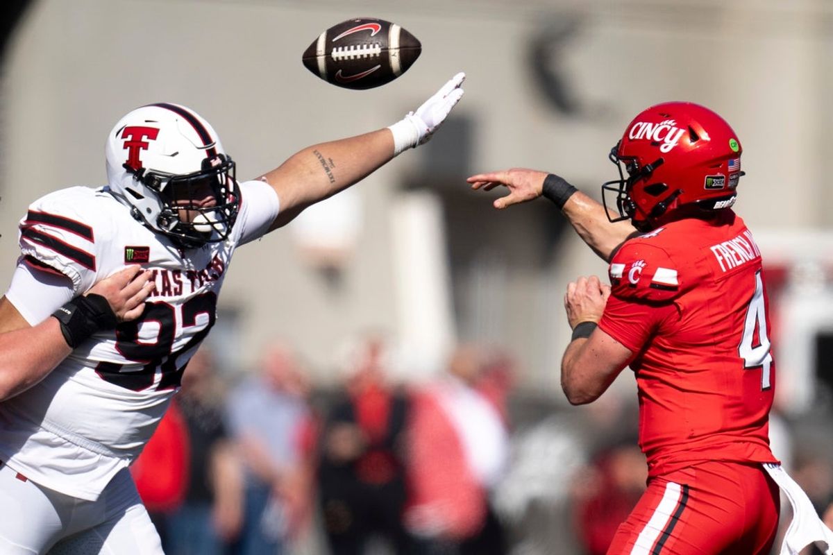 Cincinnati Bearcats quarterback JC French IV (4) throws a pass as Texas Tech Red Raiders defensive lineman Bryce Butler (92) defends in the second quarter of the Big 12 game between Cincinnati Bearcats and Texas Tech at Nippert Stadium in Cincinnati on Saturday, October 24, 2026.