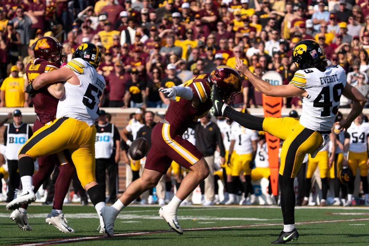 Minnesota’s Mason Carrier (46) blocks a punt attempt by Iowa Hawkeyes punter Boston Everitt (49) Oct. 24, 2026 during a Big Ten football game in Minneapolis, Minnesota.