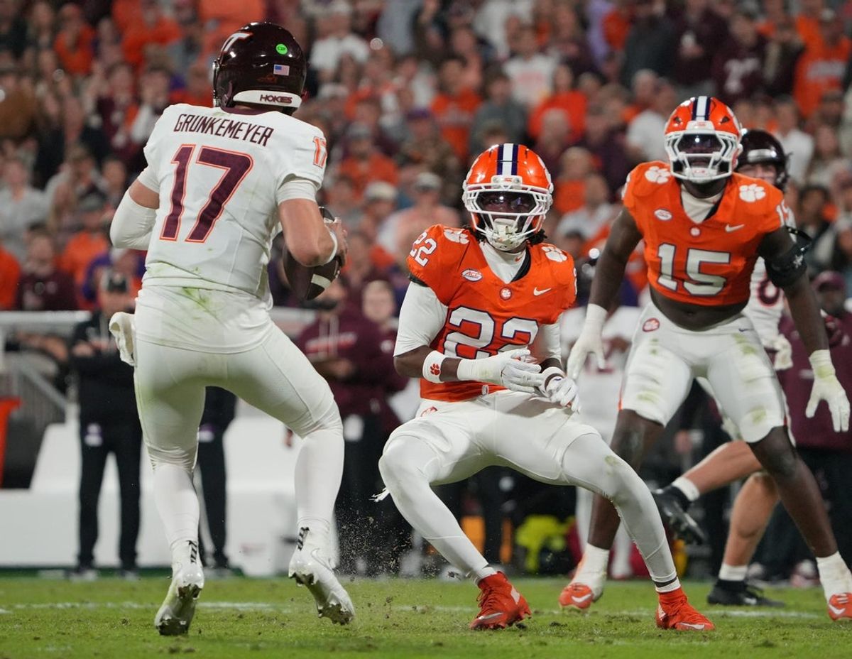 Virginia Tech Hokies quarterback Ethan Grunkemeyer (17) passes a ball despite pressure from Clemson safety Corey Myrick (22) and defensive end Jahiem Lawson (15) during the second quarter at Memorial Stadium Saturday, October 24, 2026.