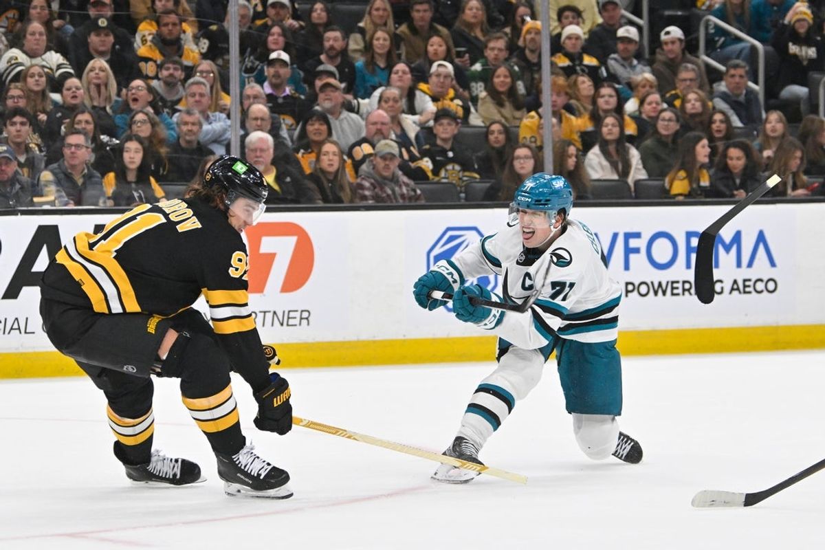 Oct 24, 2026; Boston, Massachusetts, USA; Boston Bruins defenseman Nikita Zadorov (91) loses the head of his stick defending against San Jose Sharks center Macklin Celebrini (71) during the second period at TD Garden. Mandatory Credit: Eric Canha-Imagn Images