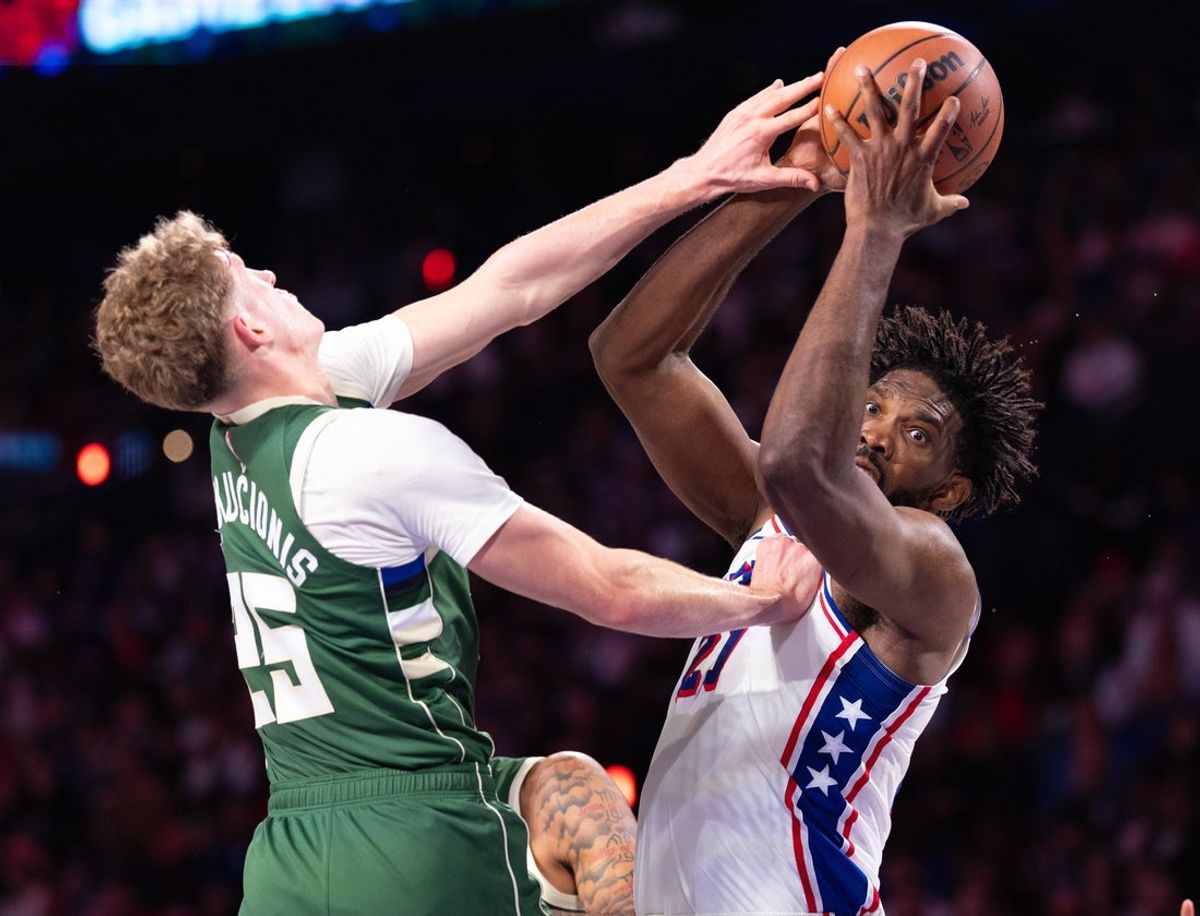Oct 24, 2026; Philadelphia, Pennsylvania, USA; Philadelphia 76ers center Joel Embiid (21) rebounds the ball against Milwaukee Bucks guard Kasparas Jakucionis (25) during the second quarter at Xfinity Mobile Arena. Mandatory Credit: Bill Streicher-Imagn Images