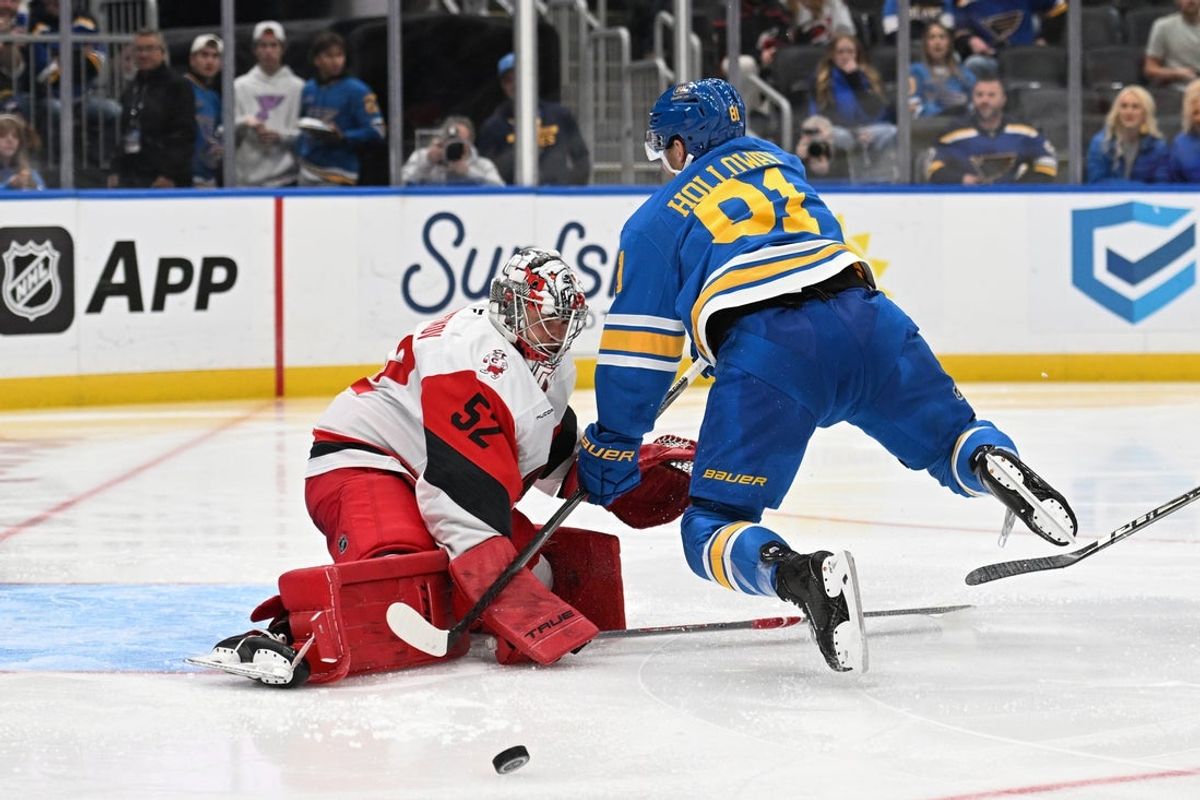 Oct 24, 2026; St. Louis, Missouri, USA;  St. Louis Blues left wing Dylan Holloway (81) falls into Carolina Hurricanes goaltender Pyotr Kochetkov (52) in the second period at Enterprise Center.  Mandatory Credit: Joe Puetz-Imagn Images