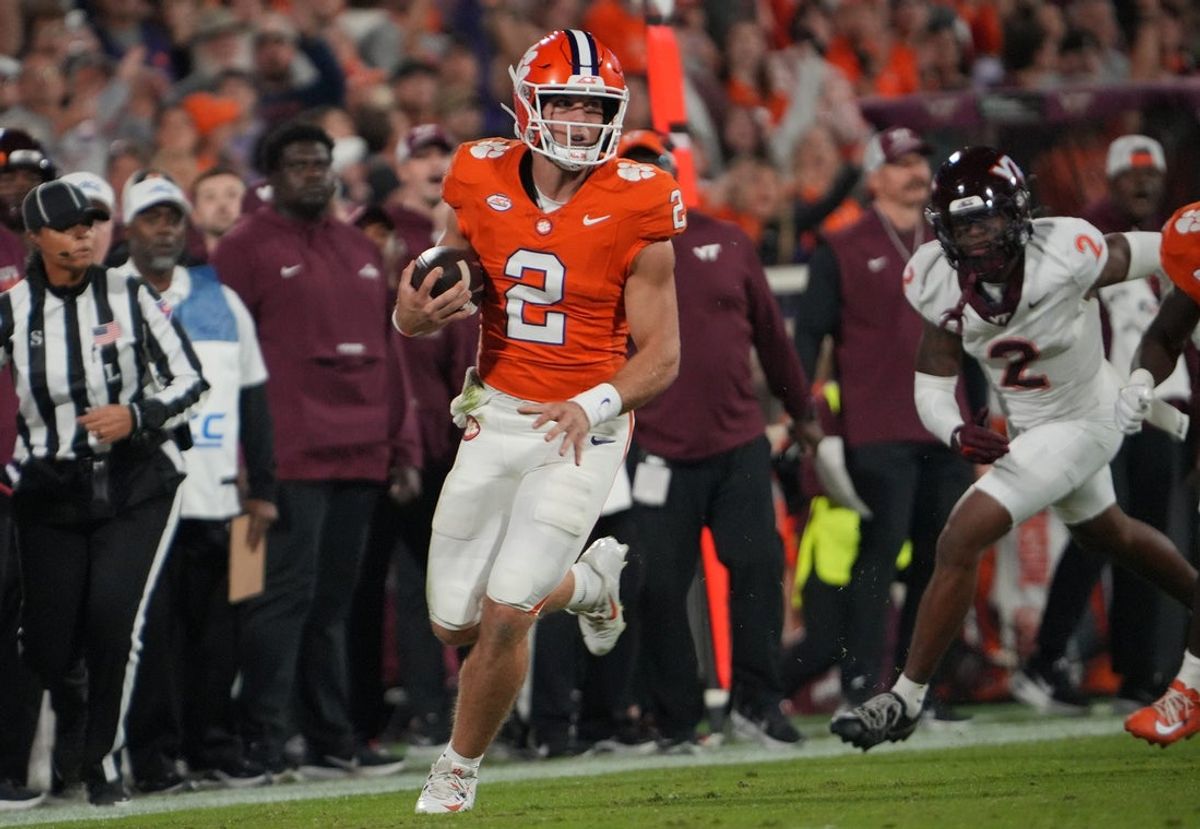 Clemson quarterback Tait Reynolds (2) runs by Virginia Tech Hokies cornerback Jaquez White (2) during the first quarter at Memorial Stadium Saturday, October 24, 2026.