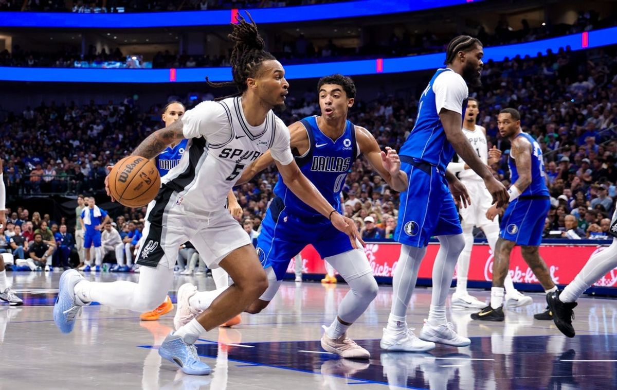 Oct 24, 2026; Dallas, Texas, USA;  San Antonio Spurs guard Stephon Castle (5) drives to the basket as Dallas Mavericks guard Max Christie (0) defends during the second quarter at American Airlines Center. Mandatory Credit: Kevin Jairaj-Imagn Images