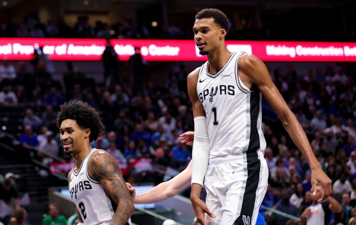 Oct 24, 2026; Dallas, Texas, USA;  San Antonio Spurs center Victor Wembanyama (1) and San Antonio Spurs guard Dylan Harper (2) laugh during the fourth quarter against the Dallas Mavericks at American Airlines Center. Mandatory Credit: Kevin Jairaj-Imagn Images