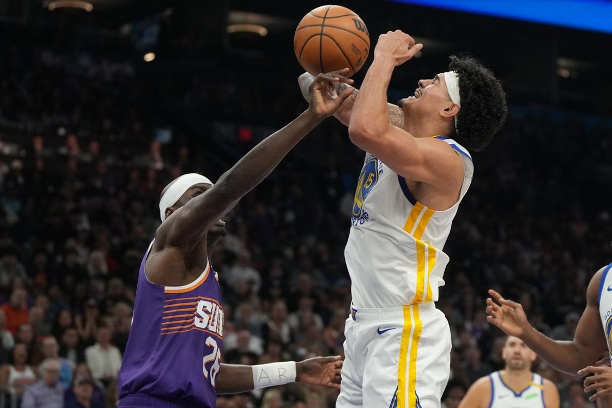 Oct 24, 2026; Phoenix, Arizona, USA;  Phoenix Suns center Duop Reath (26) fouls Golden State Warriors forward Gui Santos (15) in the first half at Mortgage Matchup Center.  Mandatory Credit: Rick Scuteri-Imagn Images