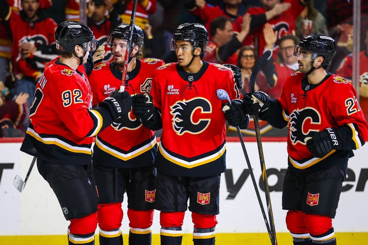 Oct 24, 2026; Calgary, Alberta, CAN; Calgary Flames defenseman Zayne Parekh (19) celebrates his goal with teammates against the Detroit Red Wings during the second period at Scotiabank Saddledome. Mandatory Credit: Sergei Belski-Imagn Images
