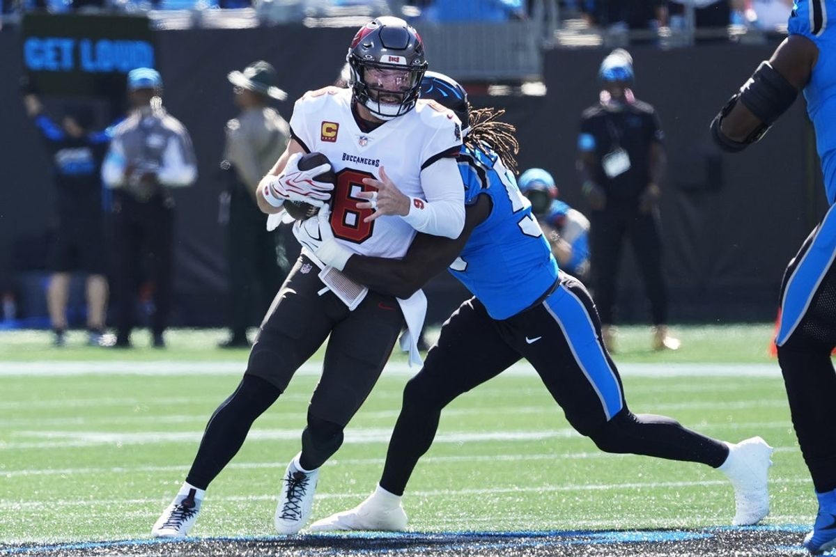 Oct 25, 2026; Charlotte, North Carolina, USA;  Carolina Panthers linebacker Devin Lloyd (55) sacks Tampa Bay Buccaneers quarterback Baker Mayfield (6) during the first half at Bank of America Stadium.  Mandatory Credit: Jim Dedmon-Imagn Images