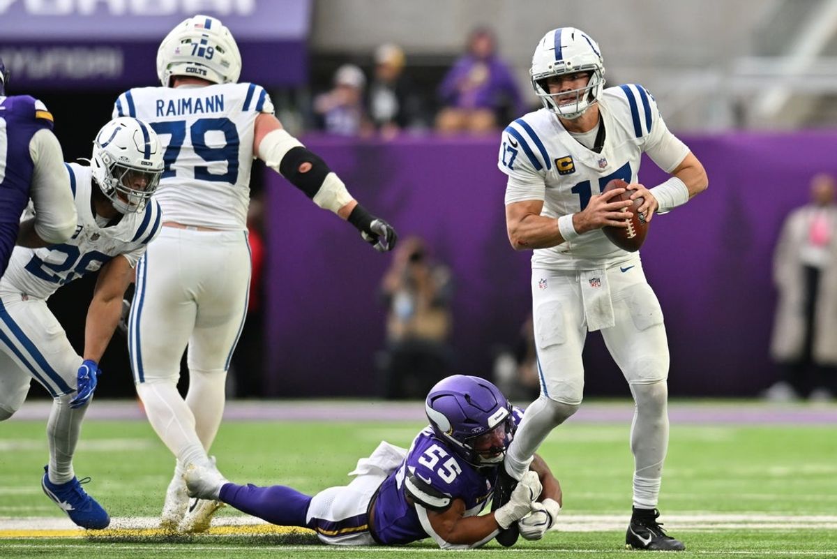 Oct 25, 2026; Minneapolis, Minnesota, USA;  Indianapolis Colts quarterback Daniel Jones (17) avoids the tackle of Minnesota Vikings linebacker Eric Wilson (55) at U.S. Bank Stadium.  Mandatory Credit: Jeffrey Becker-Imagn Images