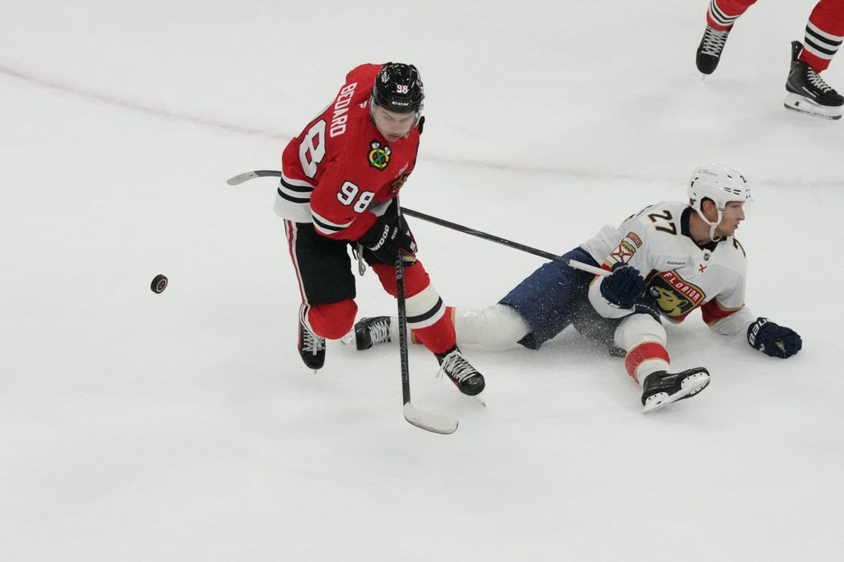 Oct 25, 2026; Chicago, Illinois, USA;  Florida Panthers center Eetu Luostarinen (27) blocks the shot of Chicago Blackhawks center Connor Bedard (98) during the second period at United Center.  Mandatory Credit: David Banks-Imagn Images