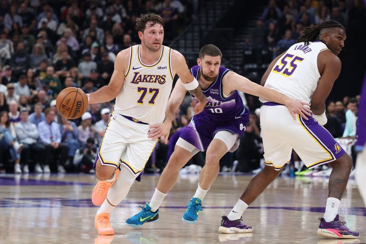 Oct 25, 2026; Salt Lake City, Utah, USA;  Los Angeles Lakers guard Luka Doncic (77) uses a screen by forward Kevon Looney (55) against Utah Jazz guard Svi Mykhailiuk (10) during the first half at Delta Center.  Mandatory Credit: Rob Gray-Imagn Images