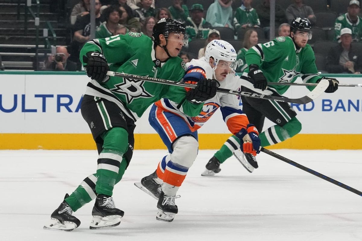 Oct 25, 2026; Dallas, Texas, USA;  Dallas Stars left wing Jason Robertson (21) clears the puck as New York Islanders center Jean-Gabriel Pageau (44) applies pressure during the first period at American Airlines Center. Mandatory Credit: Raymond Carlin III-Imagn Images