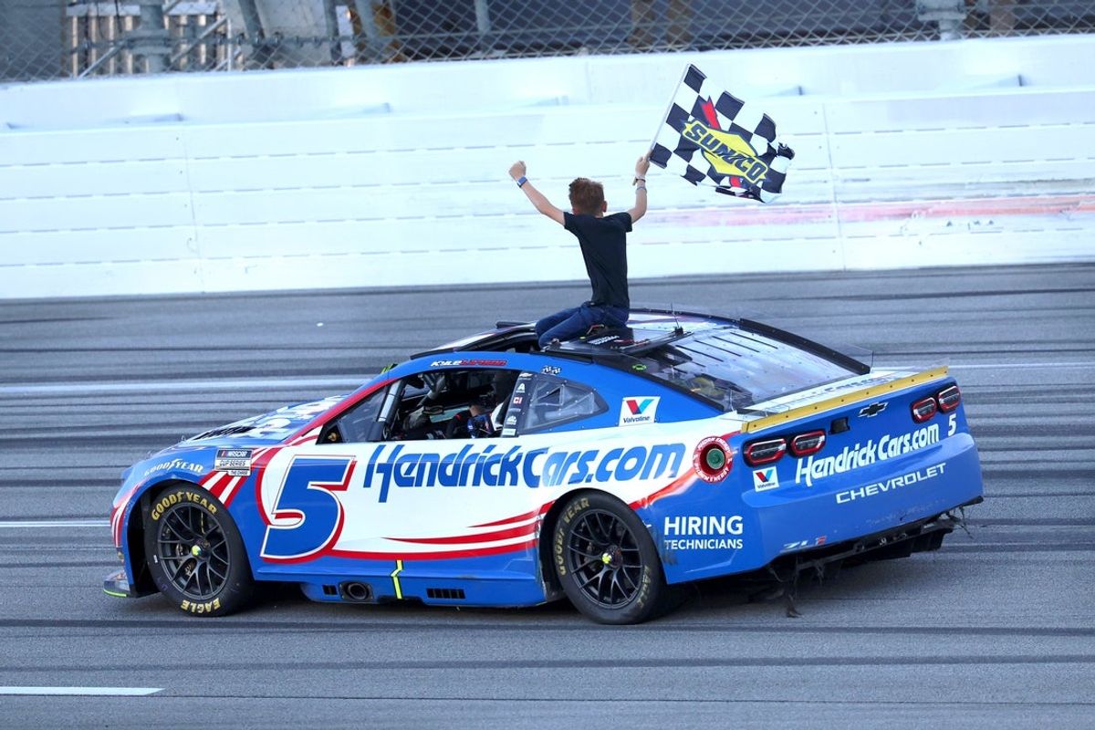 Oct 25, 2026; Talladega, Alabama, USA;  NASCAR Cup Series driver Kyle Larson (5) celebrates with his son Owen after winning the YellaWood 500 NASCAR Cup Series race at Talladega Superspeedway.  Mandatory Credit: David Leong-Imagn Images