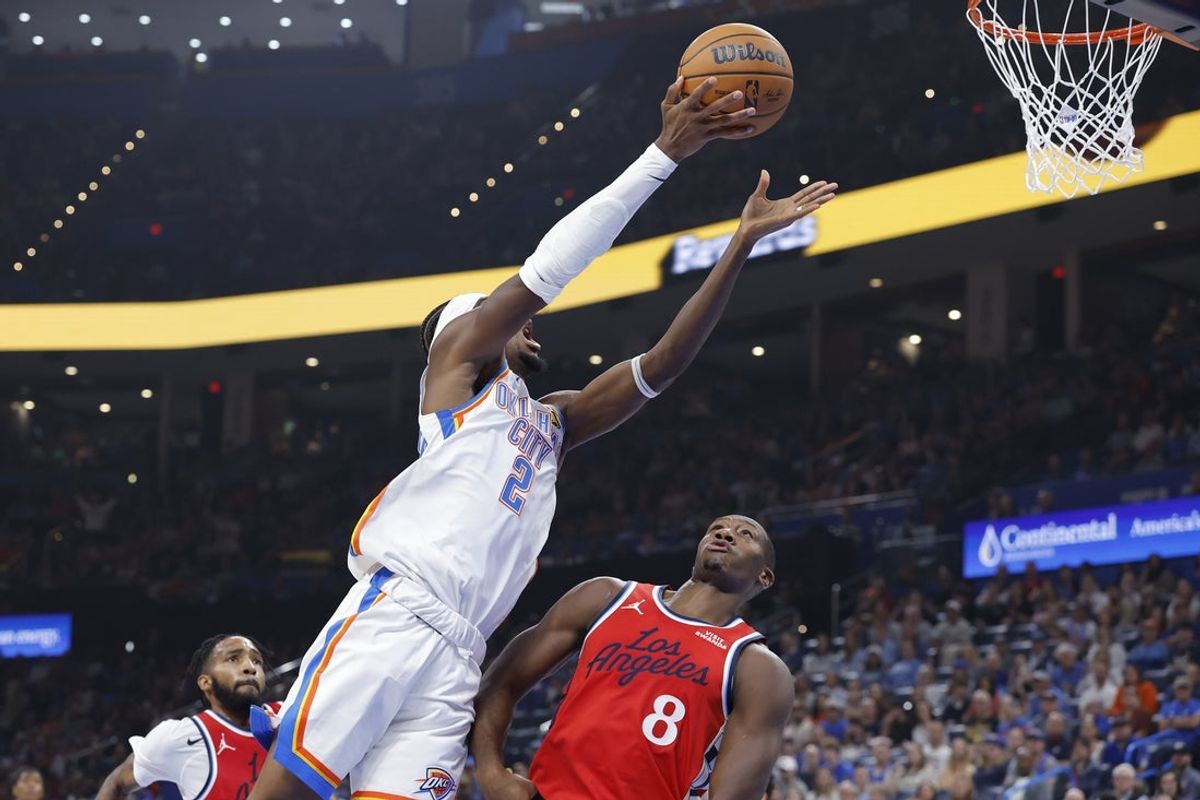 Oct 25, 2026; Oklahoma City, Oklahoma, USA; Oklahoma City Thunder guard Shai Gilgeous-Alexander (2) shoots over Los Angeles Clippers guard Kris Dunn (8) during the first half at Paycom Center. Mandatory Credit: Alonzo Adams-Imagn Images
