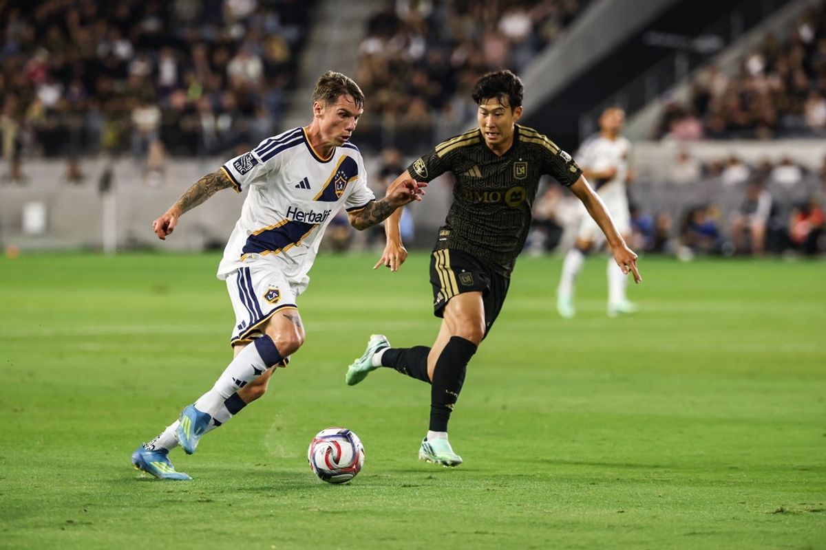 Oct 25, 2026; Los Angeles, California, USA;  LA Galaxy forward Robert Taylor (21) controls the ball against Los Angeles FC forward Son Heung-Min (7) during the first half at BMO Stadium.  Mandatory Credit: William Navarro-Imagn Images