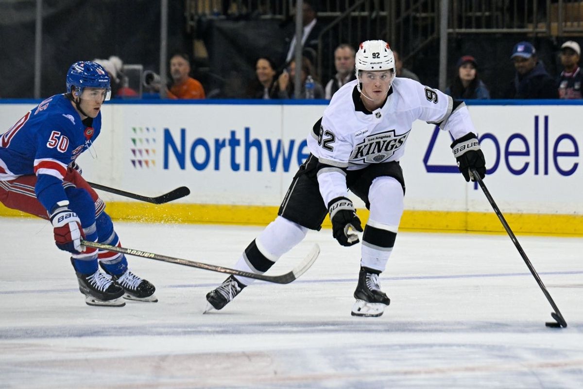 Oct 26, 2026; New York, New York, USA;  Los Angeles Kings defenseman Brandt Clarke (92) skates with the puck defended by New York Rangers left wing Will Cuylle (50) during the first period at Madison Square Garden.  Mandatory Credit: Dennis Schneidler-Imagn Images