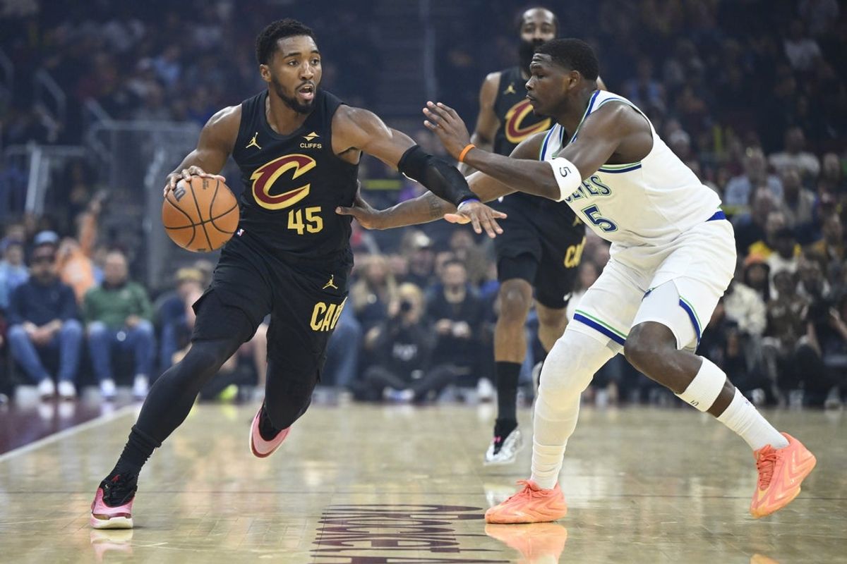 Oct 26, 2026; Cleveland, Ohio, USA;  Cleveland Cavaliers guard Donovan Mitchell (45) dribbles beside Minnesota Timberwolves guard Anthony Edwards (5) in the first quarter at Rocket Arena.  Mandatory Credit: David Richard-Imagn Images