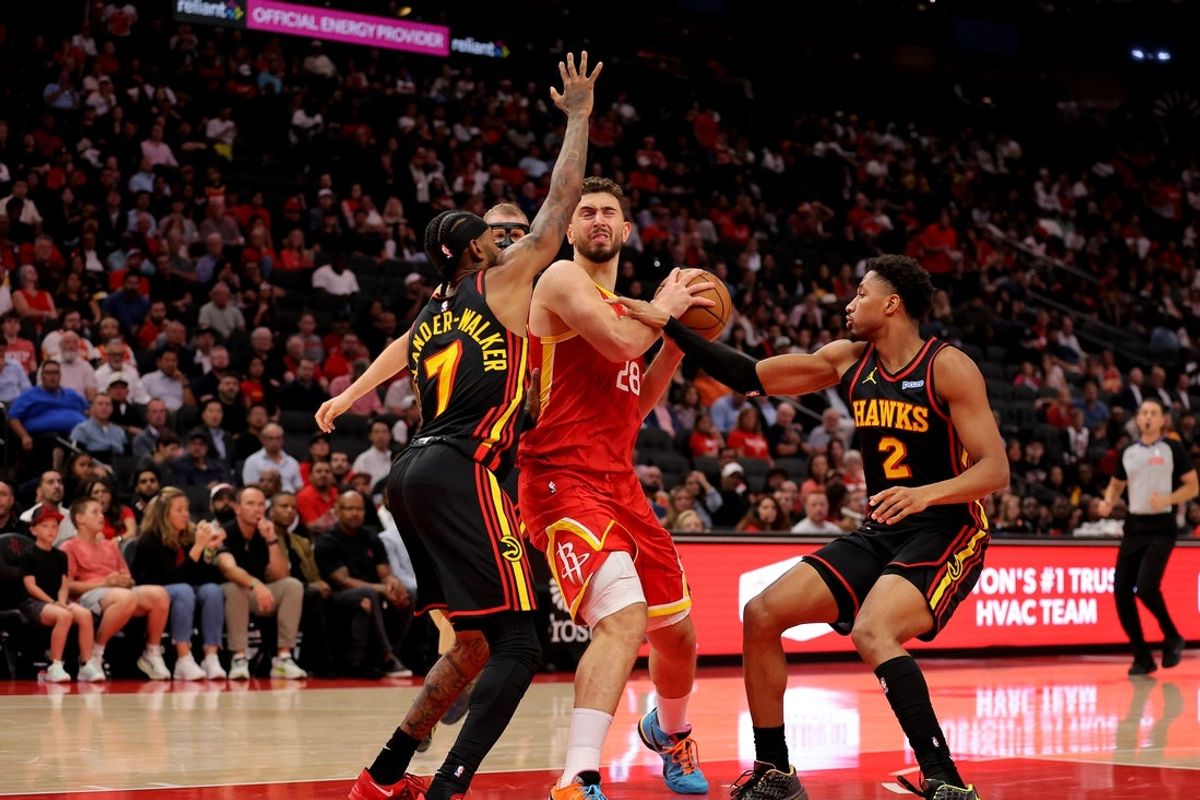 Oct 26, 2026; Houston, Texas, USA;  Houston Rockets center Alperen Sengun (28) handles the ball inside against Atlanta Hawks guards Nickeil Alexander-Walker (7) and Aaron Wiggins (2) during the second quarter at Toyota Center.  Mandatory Credit: Erik Williams-Imagn Images