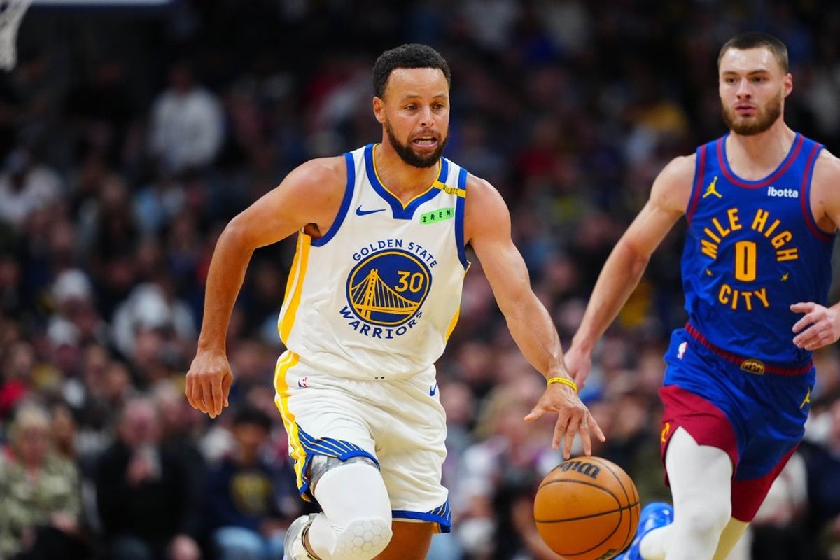 Oct 26, 2026; Denver, Colorado, USA;  Golden State Warriors guard Stephen Curry (30) drives to the net past Denver Nuggets guard Christian Braun (0) in the first quarter at Ball Arena.  Mandatory Credit: Ron Chenoy-Imagn Images