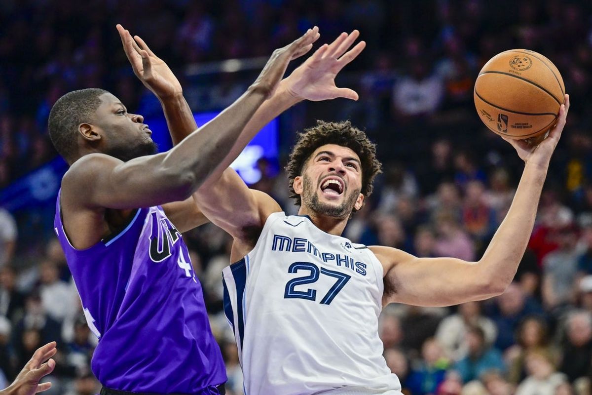 Oct 26, 2026; Salt Lake City, Utah, USA;  Memphis Grizzlies forward Cameron Boozer (27) goes for a layup against Utah Jazz center Mo Bamba (44) during the first half at Delta Center.  Mandatory Credit: Peter Creveling-Imagn Images
