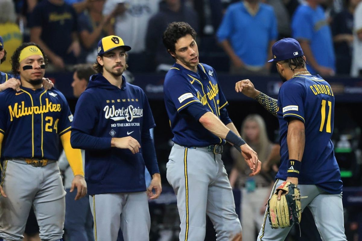 Oct 26, 2026; St. Petersburg, Florida, USA;  Milwaukee Brewers outfielder Jackson Chourio (11) celebrates with designated hitter Christian Yelich (22), pitcher Robert Gasser (54) and catcher William Contreras (24) after the last out of the game against the Tampa Bay Rays during the ninth inning in game three of the 2026 World Series at Tropicana Field.  Mandatory Credit: Kim Klement Neitzel-Imagn Images