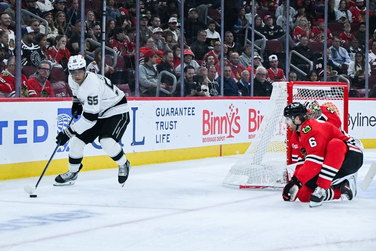 Oct 27, 2026; Chicago, Illinois, USA;  Los Angeles Kings right wing Quinton Byfield (55) moves there puck past Chicago Blackhawks defenseman Sam Rinzel (6) during the first period at United Center.  Mandatory Credit: Matt Marton-Imagn Images