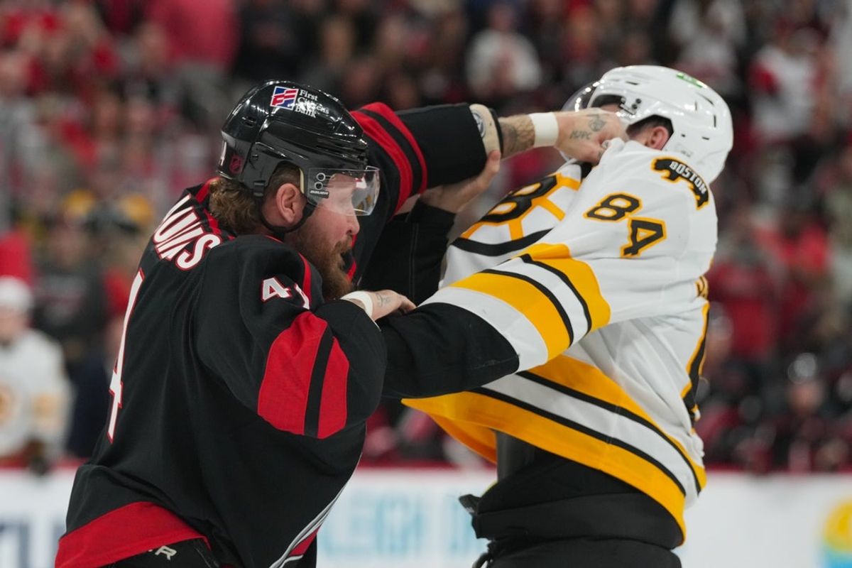 Oct 27, 2026; Raleigh, North Carolina, USA;  Carolina Hurricanes left wing Nicolas Deslauriers (44) and Boston Bruins left wing Tanner Jeannot (84) fight during the first period at Lenovo Center.  Mandatory Credit: James Guillory-Imagn Images