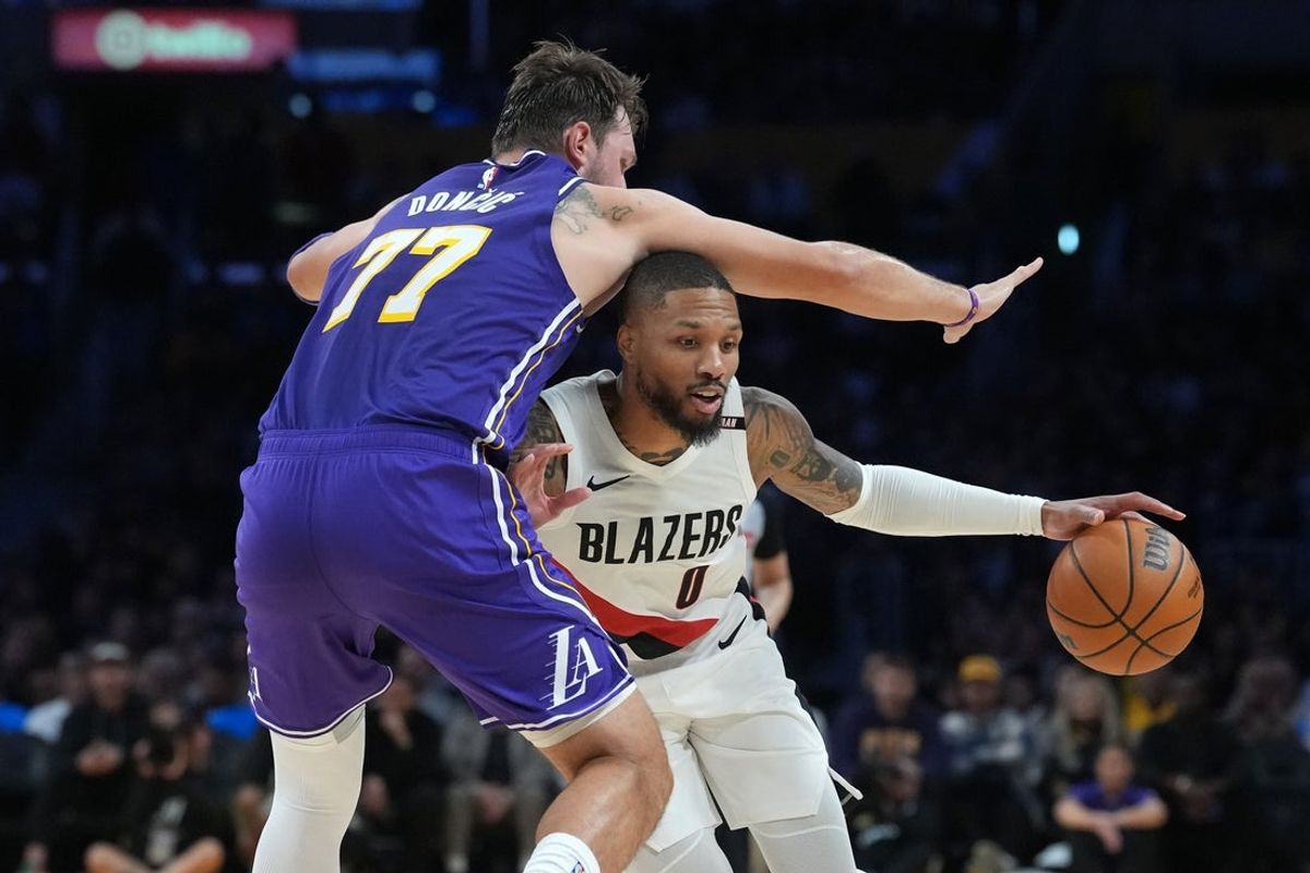 Oct 27, 2026; Los Angeles, California, USA; Portland Trail Blazers guard Damian Lillard (0) dribbles the ball against Los Angeles Lakers guard Luka Doncic (77) in the first half at Crypto.com Arena. Mandatory Credit: Kirby Lee-Imagn Images