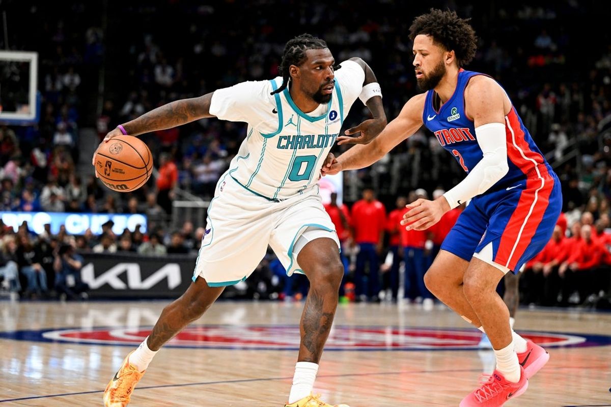 Oct 28, 2026; Detroit, Michigan, USA;  Charlotte Hornets center Naz Reid (0) drives to the basket against Detroit Pistons guard Cade Cunningham (2) in the first quarter at Little Caesars Arena.  Mandatory Credit: Lon Horwedel-Imagn Images